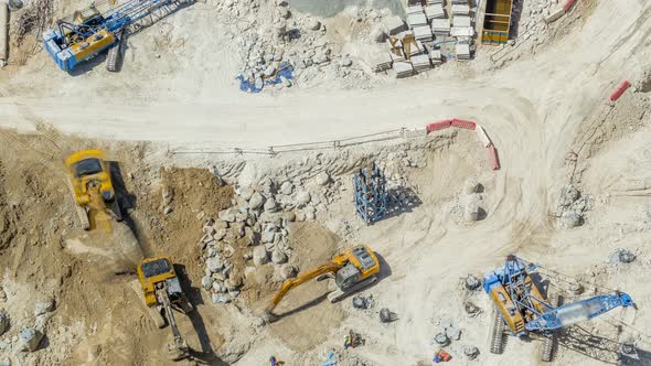 Large Construction Site Including Several Excavators and Cranes Timelapse Working on a Building alt