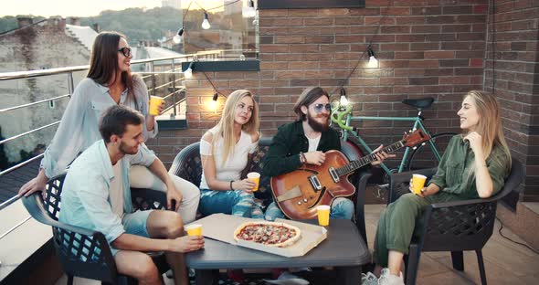 Group of Friends Relaxing on Terrace