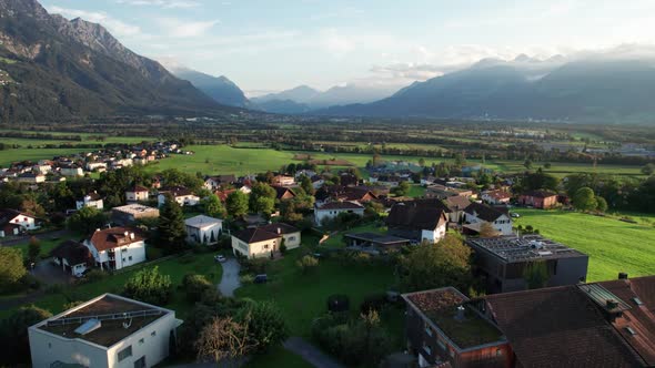 Aerial View of Liechtenstein with Houses on Green Fields in Alps Mountain Valley alt
