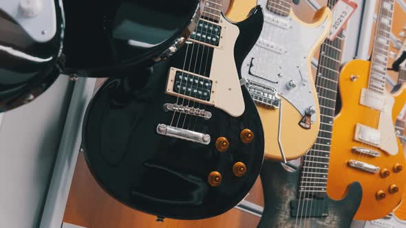 Many New Different Multicolored Electric Guitars are Sold in the Store alt