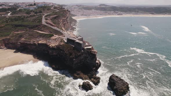 Nazare Lighthouse and Fortress of Saint Michael the Archangel, Portugal. Panoramic aerial view alt