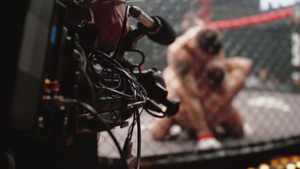 Professional TV Camera Shoots That MMA Fighters Spar in Octagonal Ring Cage alt