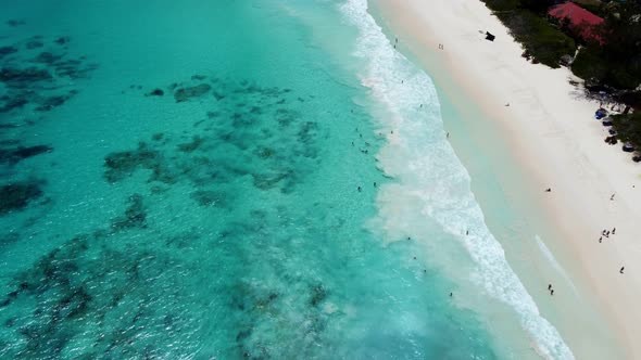 azure beach with big waves from a height