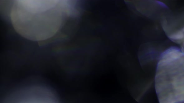 Blurred Black and White Abstract Bokeh of Blinking Defocused Holiday Lights on Dark Background alt