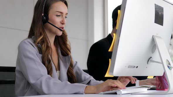 young beautiful women call center wear headset and working with computer while consulting customer alt