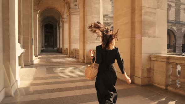 Slow Motion of Woman in Black Dress Running Outdoors in Paris alt
