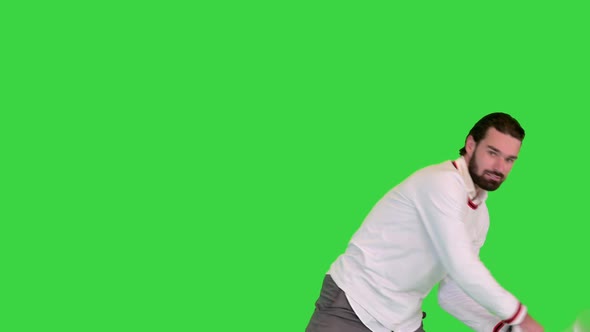 Young Man Doing Imitation of Playing Tennis on a Green Screen Chroma Key