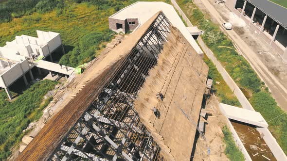Aerial View the Roof of a Large House with Dry Straw and Hay. Workers Who Install the Roof alt