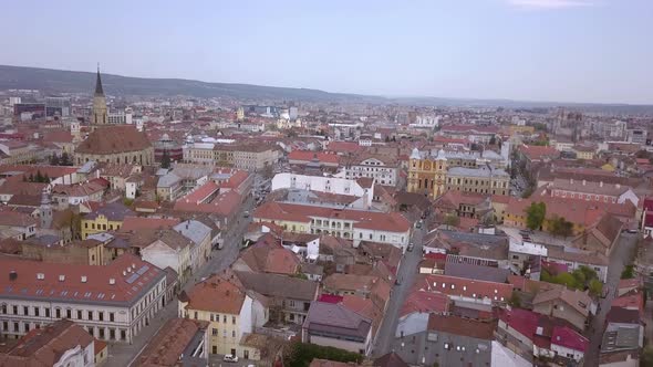 Drone shot flying above the center of Cluj in Romania on a sunny day alt