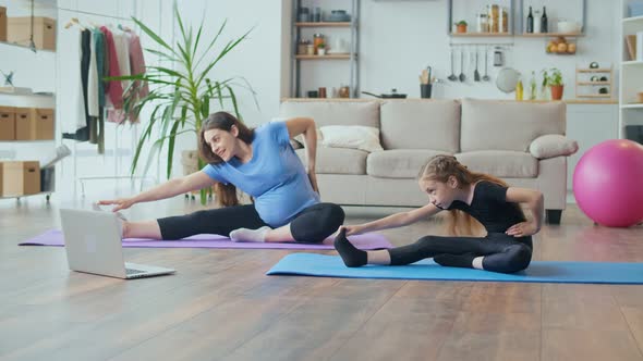 Pregnant Mother and Child Go in for Sports at Home Online alt