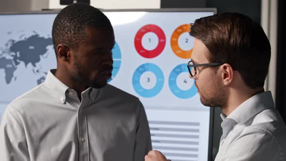 Two colleagues discussing business strategy on infographics background alt