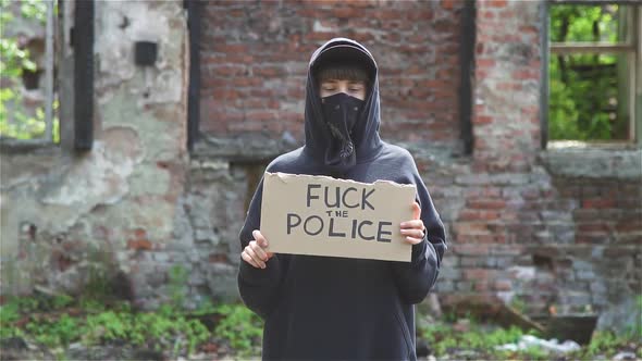 Young Woman Protesting Against Police Covering Face With Bandana And Wearing alt