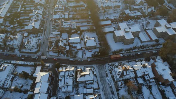 Snowy Streets and Houses in the Early Morning Aerial View alt