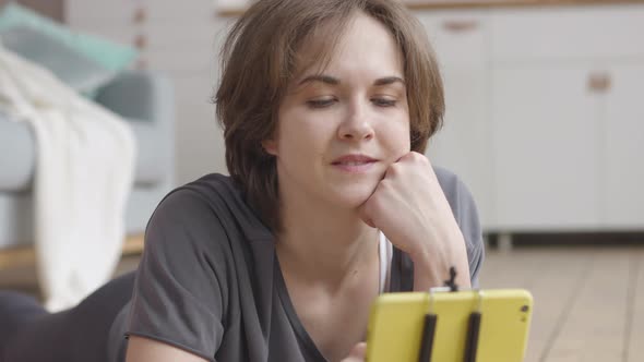 Young Woman Chooses Best Mobile Fitness App