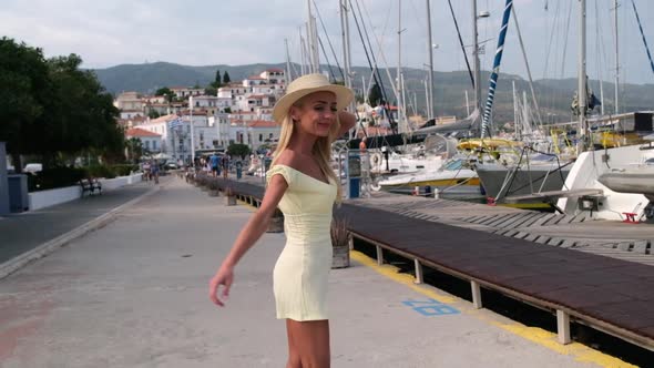 Beautiful Girl Tourist Walking at Marina Sea Port of Poros City Greece alt