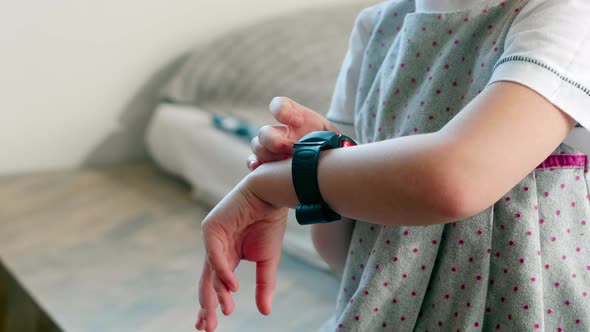 Little Girl Setting Up Smartwatches