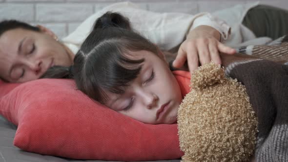 Sleeping Girl with Toy By Mother alt