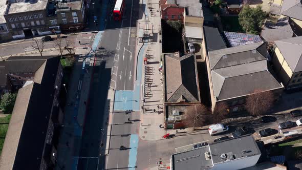 Pan up reveal aerial drone shot of city of London buildings from Whitechapel road alt