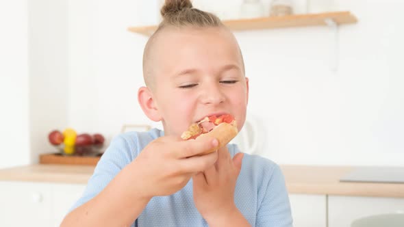 Young Family Deliciously Eating Italian Pizza Sitting in the Kitchen at the Table alt