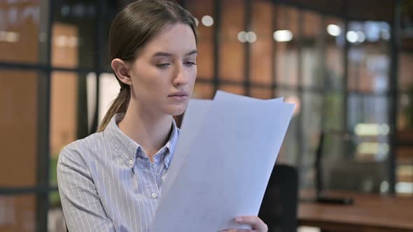 Young Woman Reading Documents, Doing Paperwork alt