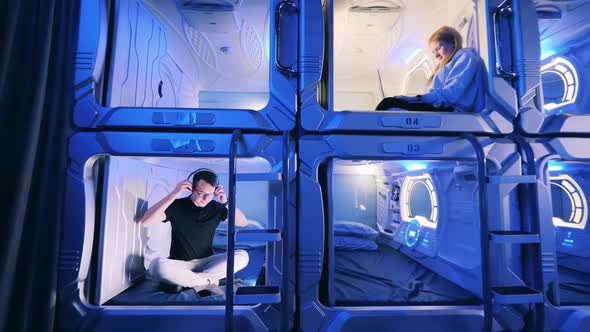 Young Man and Woman in the Capsule Hotel Rooms alt