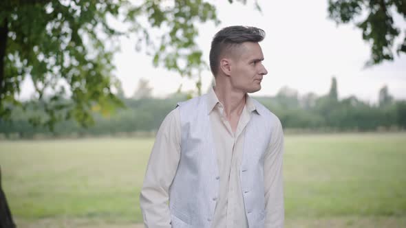 Portrait of Nervous Dissatisfied Boyfriend Waiting for Girlfriend in Summer Park. Unhappy Stressed alt
