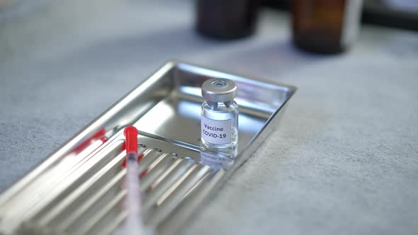 High Angle View Covid19 Vaccine on Metal Tray with Sterile Syringe Closeup alt