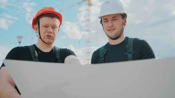 An Builders Are Studying Construction Plan and Analyze Are Building Construction. alt