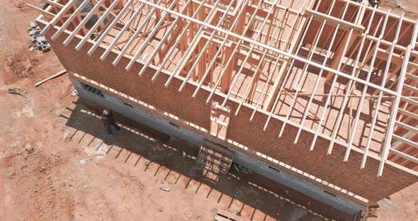 Framing of Under Construction Wooden House Building Frame Structure on New Development alt