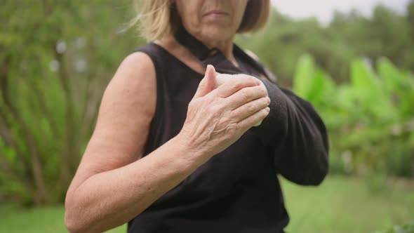 Senior Elderly Woman Massaging Hand Suffering From Joint Pain