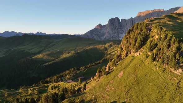 Dolomites mountains peaks with a hiking path on a summer sunrise alt