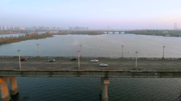 Aerial View Car Traffic on River Bridge at Evening