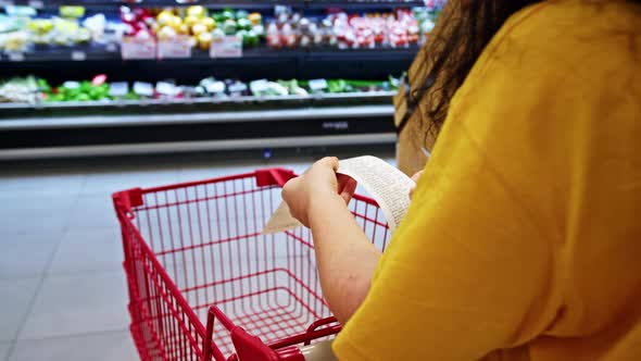 Woman Checks Paper Receipt Previous Purchase Compares Large Increase in Food Priceswoman in Shopping alt