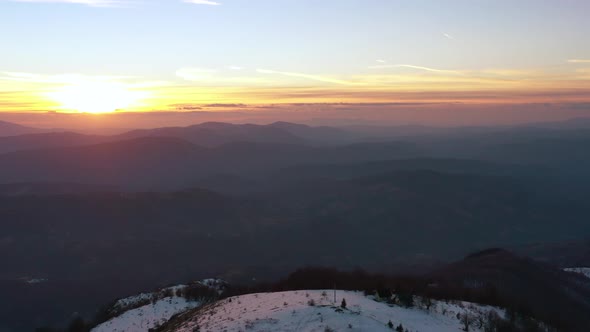 Aerial view at the mountain on a sunset of the winter day