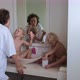Mom with Children in the Bathroom Brushes Her Teeth in the Morning - VideoHive Item for Sale
