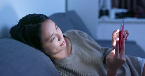 Woman use of smart phone at night alt