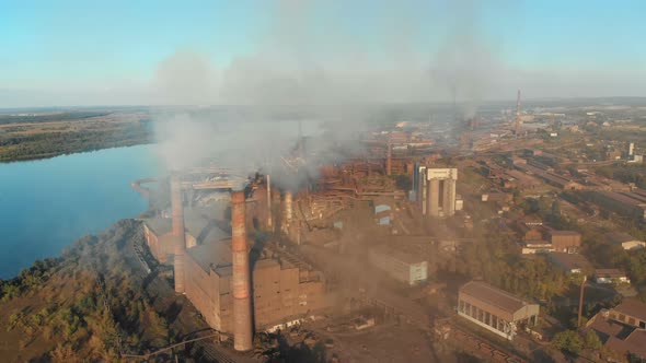 Industrial Plant with Smoking Pipes Near the City alt