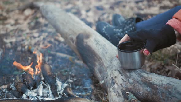 Traveler Girl Pouring Tea From Thermos Cup During Hike. Woman Pouring a Hot Drink in Mug From alt