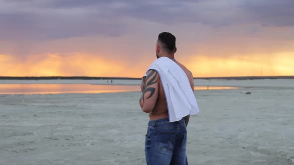 Masculine Man on Shore at Sunset