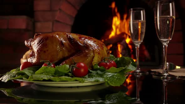 Christmas Baked Chicken with the Salad and Tomatoes on a Background of Fireplace alt