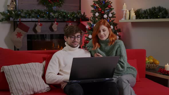 Couple having Video Call on laptop at Home. alt