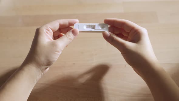 close up positive show result of covid negative show on nasal rapid self test kit alt