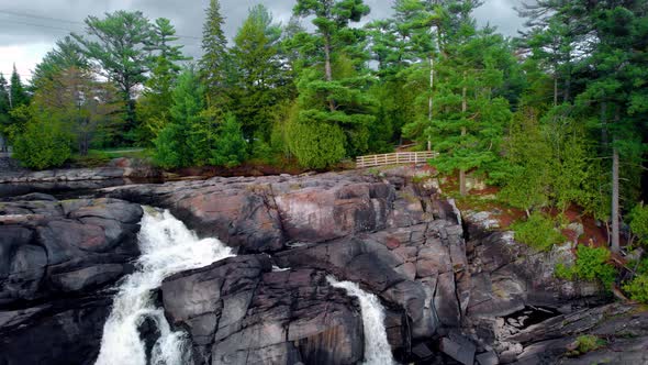 Scenic Forest lookout point with flowing waterfall and rocky escarpment alt