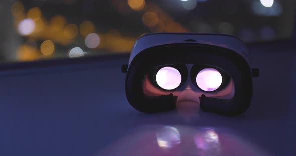 Playing movie inside VR device with city background at night alt