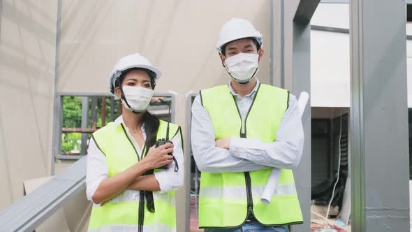 Asian construction workers people wearing protective face mask onsite of architecture due to covid19 alt