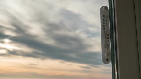Temperature Thermometer Outside the Window and Changing Weather in Timelapse alt