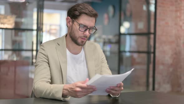 Young Man Reading Documents alt