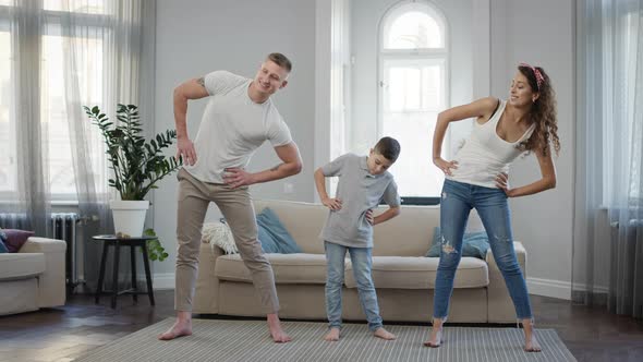 Dad Mom And Son Doing Exercise In The Apartment alt