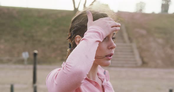 Caucasian woman tired after exercising at bootcamp alt