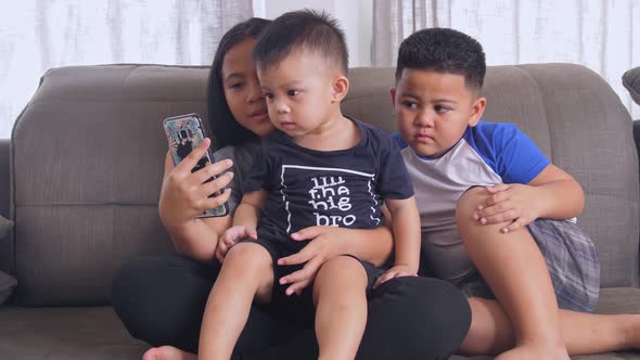 Asian Children Playing Smartphone alt